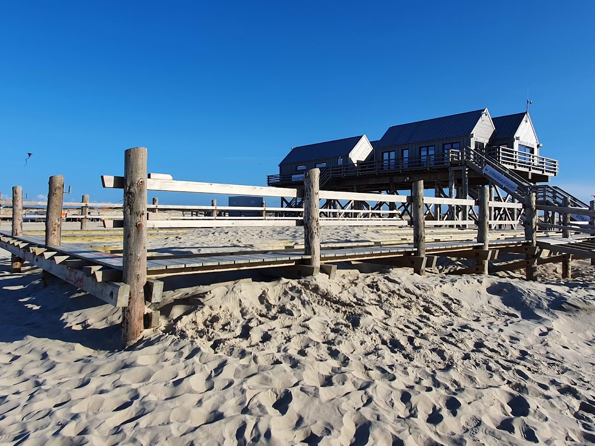 Paalwoning met houten steiger op het strand van St. Peter-Ording