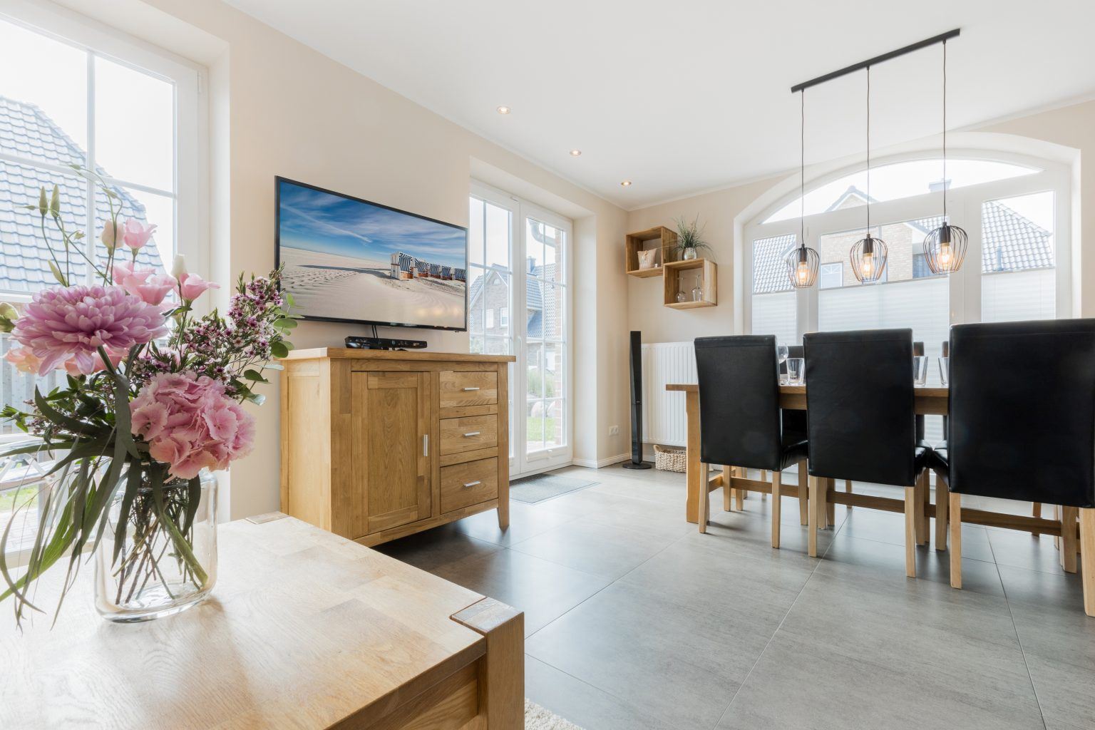 Åben stue og spiseplads med stor sofa